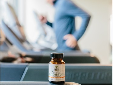Natural supplement bottle in front of treadmills.